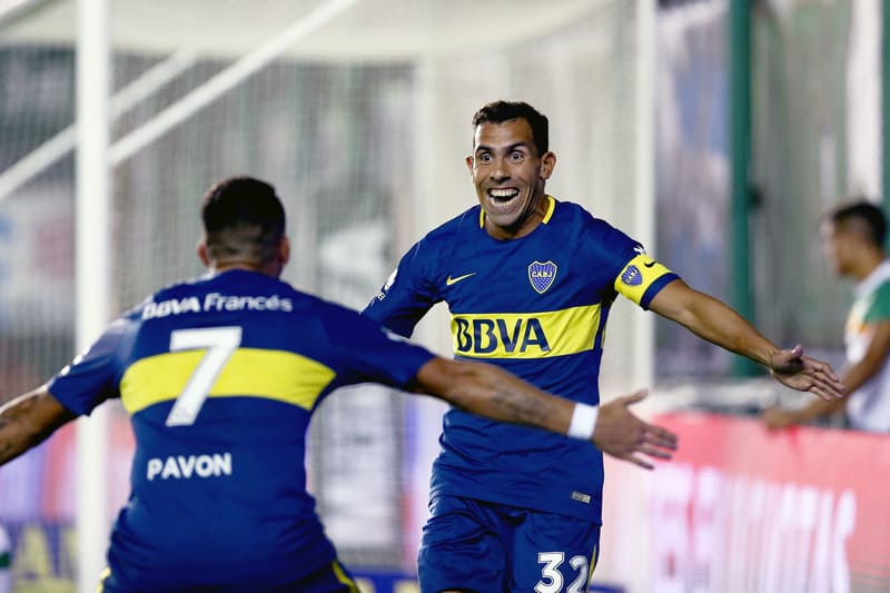 Two soccer players celebrating after scoring a goal in an Argentina Primera Division match