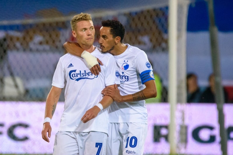 Two soccer players embracing after a match in Danish Superligaen