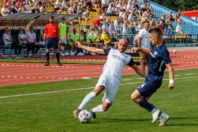 Two soccer players competing for the ball in a Ukrainian Premier League match